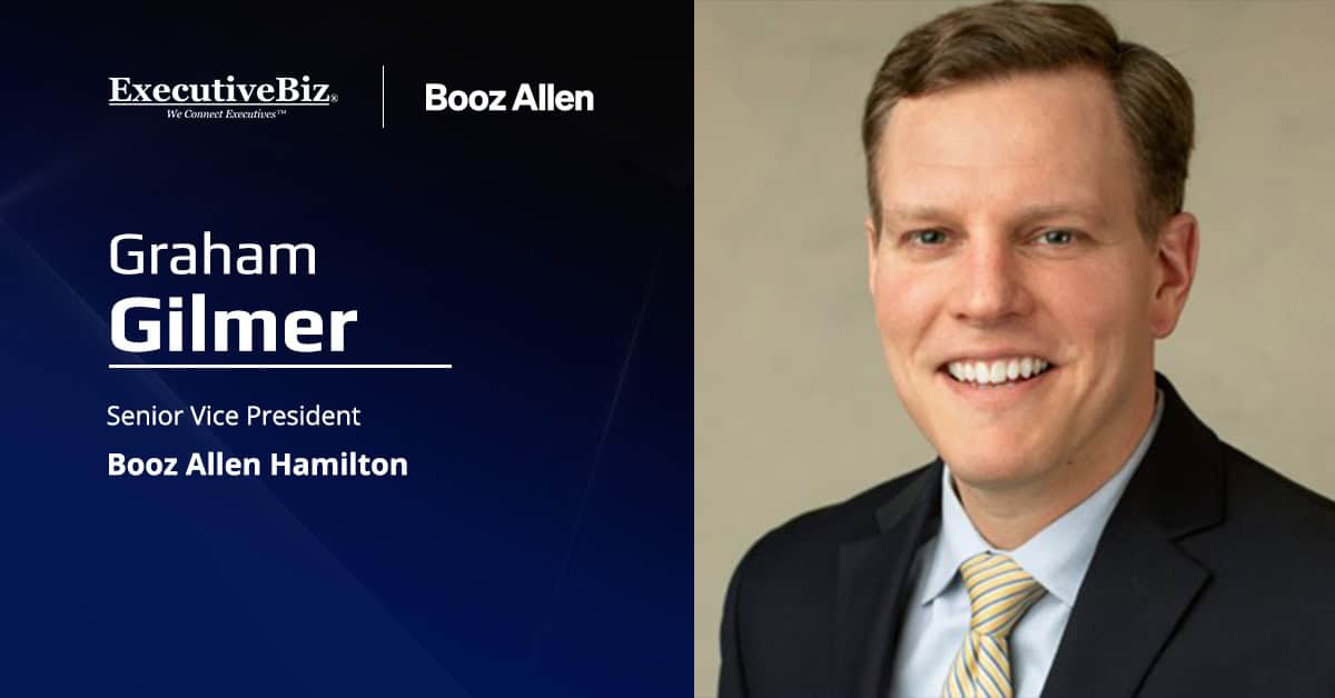 Graham Gilmer. The Booz Allen SVP cited the federal adoption of a hybrid infrastructure model as AI moves to operational use.